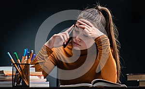 Young beautiful but stressed student girl studying for hard exam