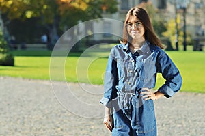 A young beautiful student of Asian appearance is standing next to the University Park