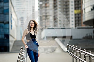 Young beautiful stylish hipster woman drinking coffee in paper