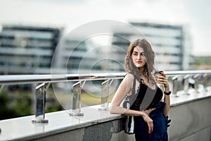 Young beautiful stylish hipster woman drinking coffee in paper