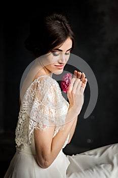 Young beautiful stylish woman, bride, spring trend, flowers, hairstyle, beauty make-up, white dress, dark background