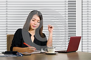 Young beautiful and successful Asian Chinese business woman working confident at modern office computer desk in female businesswom