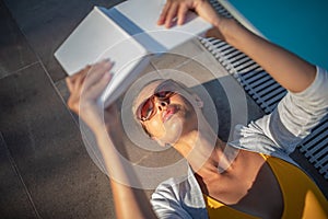 Young Beautiful Suntanned Woman wearing sunglasses