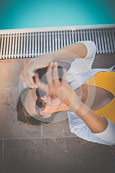 Young Beautiful Suntanned Woman wearing sunglasses relaxing