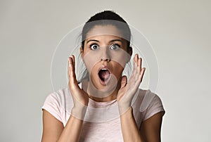 Young beautiful surprised woman amazed in shock and surprise with mouth big opened