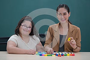 Young and beautiful teacher taking photo together in classroom with love and intimate pose