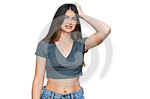 Young beautiful teen girl wearing casual crop top t shirt confuse and wonder about question