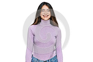 Young beautiful teen girl wearing turtleneck sweater with a happy and cool smile on face