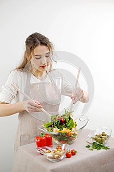 young beautiful teenage girl stirs diligently salad she leaned over bowl little smiling green lettuce leaves tablecloth