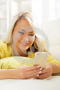 Young and beautiful teenage girl typing sms using a smartphone