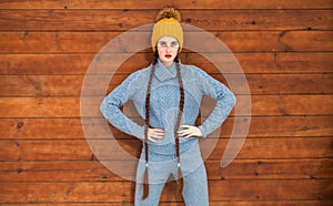 Young beautiful teenager girl posing on a wooden wall background