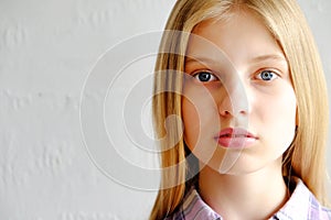 Young beautiful teenager model girl posing over white background showing emotional facial expressions.