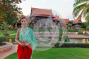 Young Beautiful Thai Asian woman dressing in vintage retro Traditional Thai costume in wait to welcome guest. Thailand Cultural