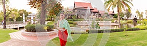 Young Beautiful Thai Asian woman dressing in vintage retro Traditional Thai costume in wait to welcome guest. Thailand Cultural