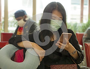 Young beautiful tourist Asian Korean tourist girl at airport wearing protective facial mask checking internet news and information