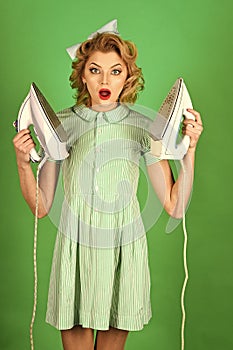 Young beautiful vintage housewife ironing