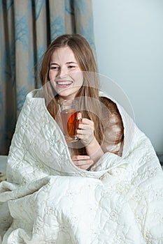 Young beautiful white woman awaking in light room.