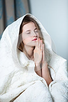 Young beautiful white woman awaking in light room.