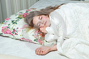 Young beautiful white woman awaking in light room. photo