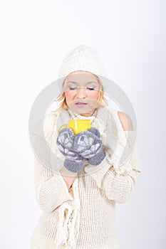 Young beautiful winter girl with cup of tea