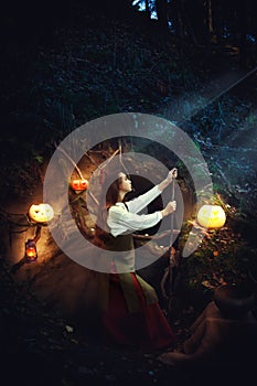 Young beautiful witch in her cave.