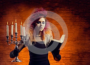 Young and beautiful witch making witchcraft