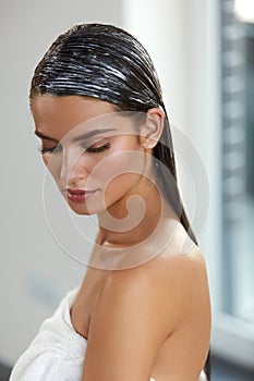 Young Beautiful Woman With Applied Natural Hair Mask. Hair Care photo