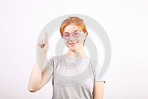 Young beautiful woman, attractive natural redhead, showing emotions, facial expressions, posing on isolated background.