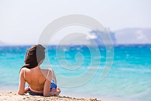 Young beautiful woman on the beach during tropical vacation. Girl enjoy her wekeend on one of the beautiful beaches in
