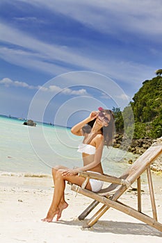 Young beautiful woman in bikini on sea background