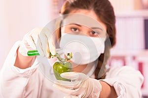 Young beautiful woman biologist experimenting with