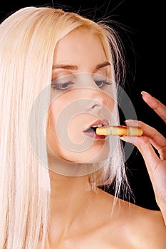 Young beautiful woman bites off cookies