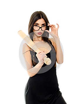 Young beautiful woman in a black dress with a baseball bat on a white background