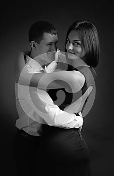 Young beautiful woman in black dress and man in white shirt dancing tango