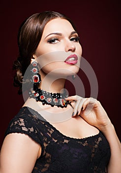 Young beautiful woman in black dress on marsala color background