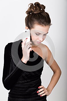 Young beautiful woman in black dress talking to your mobile phone