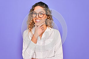 Young beautiful woman with blue eyes wearing casual shirt and glasses over purple background looking confident at the camera