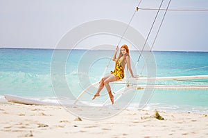 Young beautiful woman on board of sea yacht