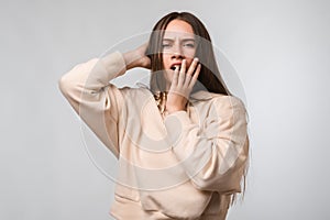 Young beautiful woman bored yawning tired covering mouth with hand. Restless and sleepiness photo