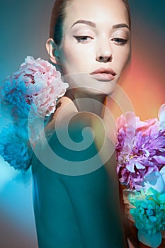 Young beautiful woman with bouquet of roses. Professional art makeup