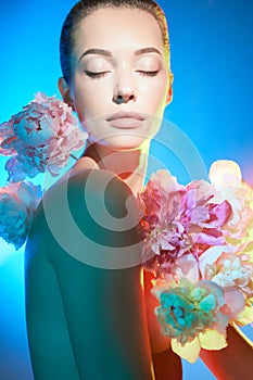 Young beautiful woman with bouquet of roses. Professional art makeup