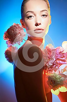 Young beautiful woman with bouquet of roses. Professional art makeup