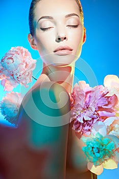 Young beautiful woman with bouquet of roses. Professional art makeup