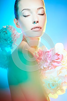 Young beautiful woman with bouquet of roses. Professional art makeup