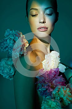 Young beautiful woman with bouquet of roses. Professional art makeup