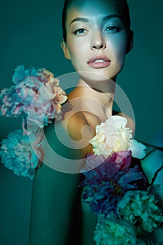 Young beautiful woman with bouquet of roses. Professional art makeup