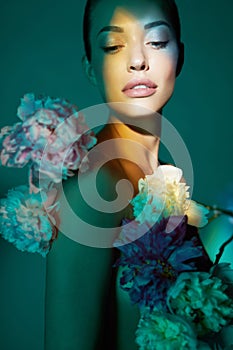 Young beautiful woman with bouquet of roses. Professional art makeup