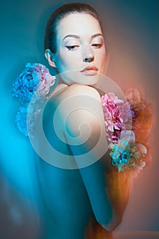 Young beautiful woman with bouquet of roses. Professional art makeup