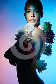 Young beautiful woman with bouquet of roses. Professional art makeup