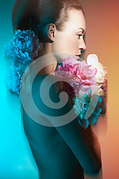 Young beautiful woman with bouquet of roses. Professional art makeup